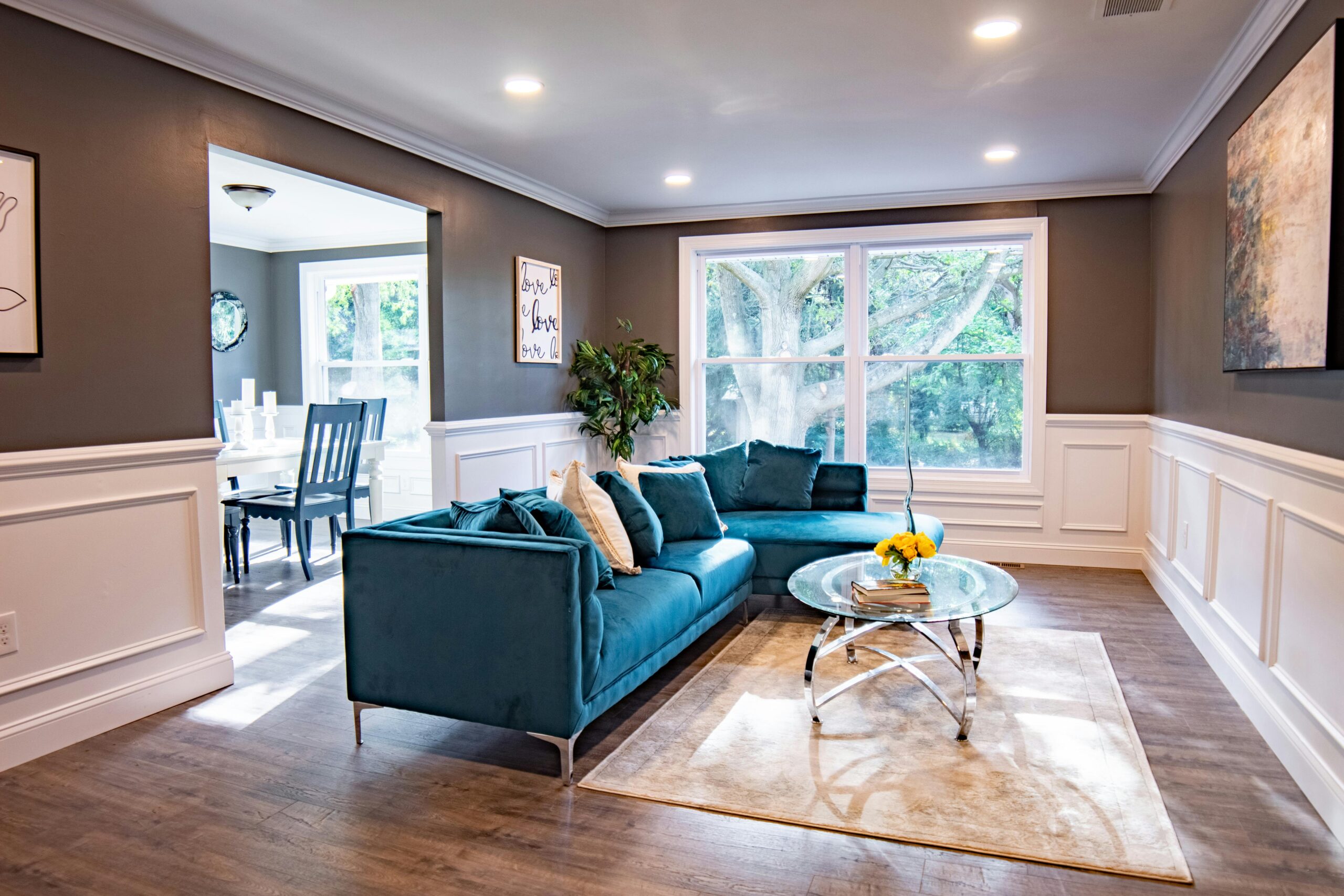 Bright modern living room featuring a turquoise sofa and a stylish decor.