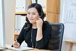 asian, vietnamese, woman, female, beautiful, smiling, lady, entrepreneur, executive, workplace, manager, listening, calling, headphones, headset, communication, talking, consulting, hotline
